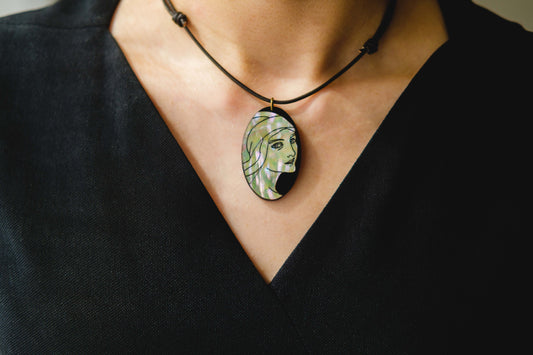 Mother of pearl necklace with engraved portrait of woman. 