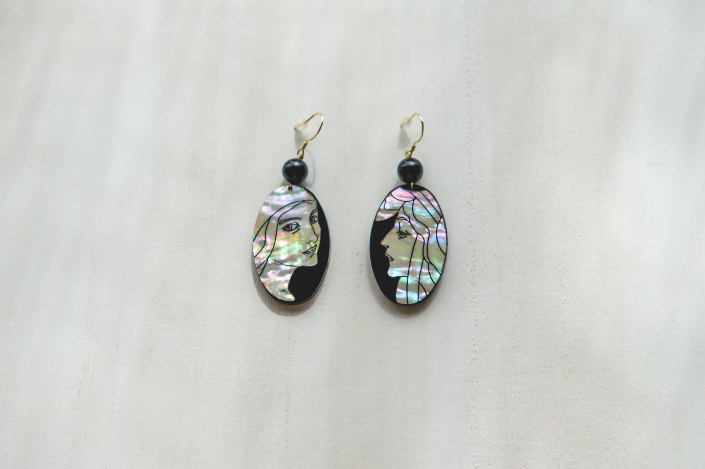 Mother of pearl earrings with engraved portrait of women in art nouveau style..